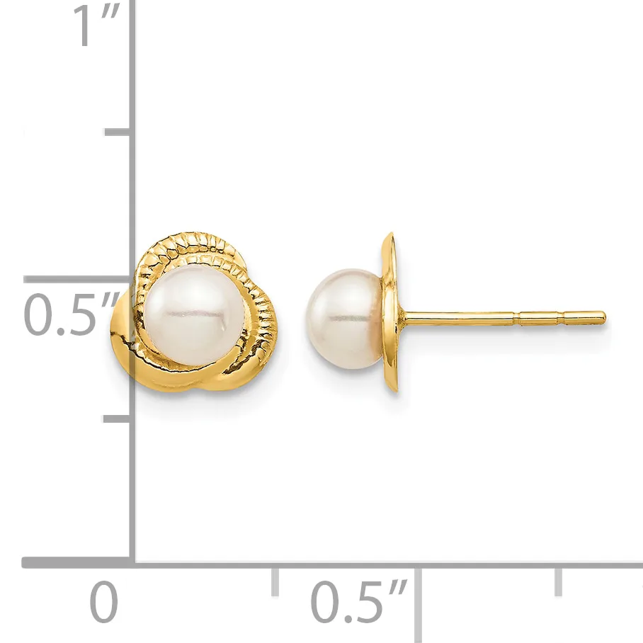 Two gold stud earrings with cream-colored pearl centers displayed next to a ruler showing approximately 0.5 inches in height.