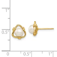 A pair of gold-toned triangular stud earrings with white pearl centers, displayed next to a ruler showing their size as approximately half an inch tall.