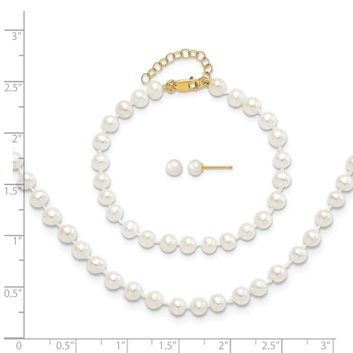 White pearl bracelet with gold clasp and matching stud earrings displayed on a measurement scale.