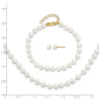 White pearl bracelet with gold clasp and matching stud earrings displayed on a measurement scale.
