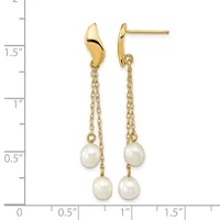 Gold-toned drop earrings with curved top posts suspending chains from which two white pearl beads hang, displayed against a measurement scale.
