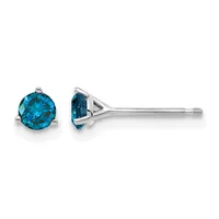 A pair of blue topaz stud earrings in silver, shown from front and side views with round faceted stones set in three-prong settings.