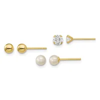 Three pairs of gold stud earrings displayed in a row: polished gold spheres, round white pearls, and round clear cubic zirconia stones in prong settings.