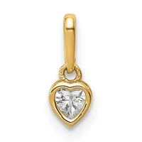 A gold heart-shaped pendant with a bezel-set clear gemstone, suspended from a plain gold bail.