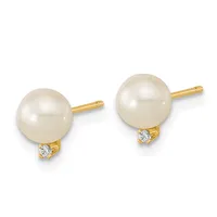 Pair of gold stud earrings with round cream pearls and small diamond accents below each pearl.
