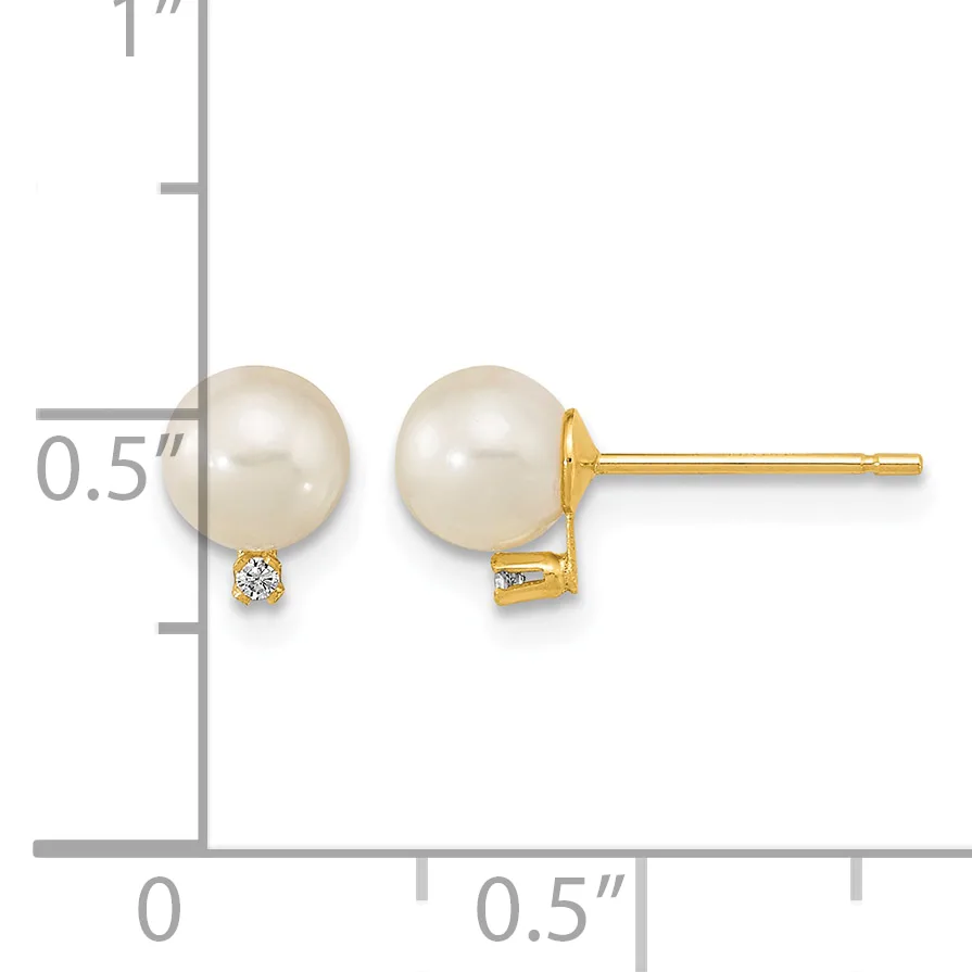A pair of gold stud earrings featuring cream-colored pearl spheres with small diamond accents, shown next to a measurement scale.