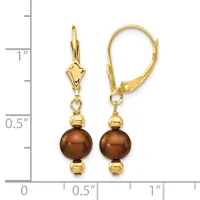 Gold-toned leverback earrings with brown pearl drops and gold spacer beads, shown next to a measurement ruler indicating approximately one inch in length.