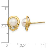 Two gold stud earrings with white pearl centers surrounded by textured gold bezels and small diamond accents, shown front and back views next to a measurement scale.