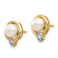 A pair of gold stud earrings with white pearls set in curved gold bezels and small diamond accents at the base.