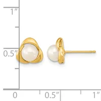 A pair of gold stud earrings with white pearl centers set in triangular gold frames, shown next to a ruler for scale.