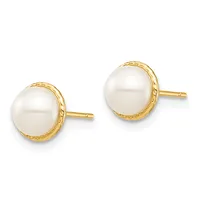 Pair of gold stud earrings with white pearl centers surrounded by textured gold bezels and gold posts.