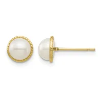 A pair of gold stud earrings with white pearl tops set in textured gold bezels, shown from front and side views.