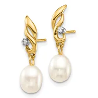 Pair of gold leverback earrings with twisted leaf-shaped tops, diamond accents, and dangling cream-colored pearl drops.