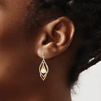 A teardrop-shaped drop earring with nested geometric frames in silver and gold tones, featuring a pearl, displayed on a model's ear.