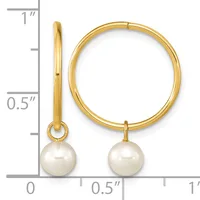 Gold hoop earrings with white pearl drops, shown from front and side views against a ruler measuring approximately one inch in diameter.