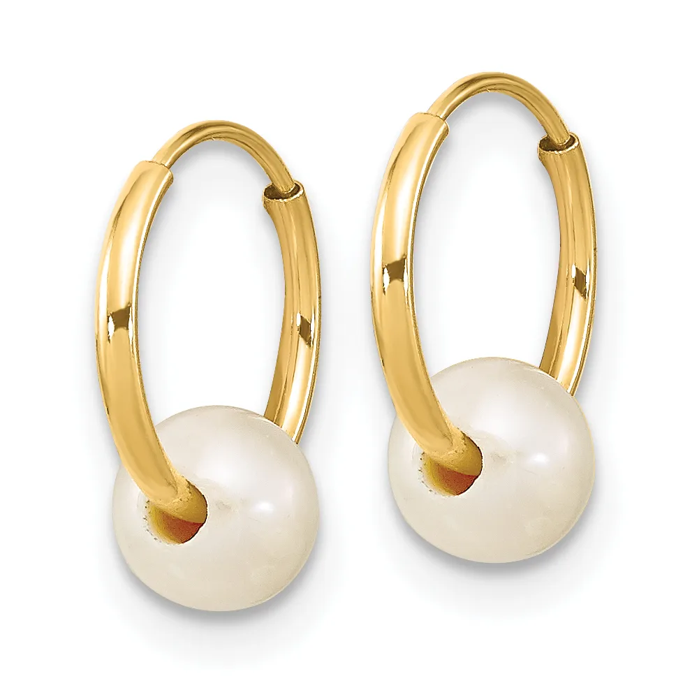 A pair of gold hoop earrings with white pearl drops attached to the hoops.