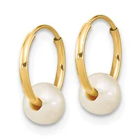 A pair of gold hoop earrings with white pearl drops attached to the hoops.