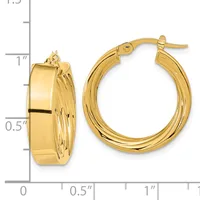 A pair of polished gold hoop earrings with textured sides, shown next to a measurement scale indicating approximately one inch in diameter.