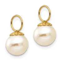 A pair of gold drop earrings featuring cream-colored pearl spheres suspended from oval loops with textured gold caps.