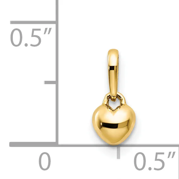 Gold heart-shaped pendant with a small loop attachment, shown next to a ruler indicating its size is approximately half an inch wide and tall.