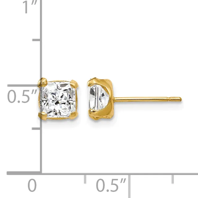 Pair of gold stud earrings with cushion-cut clear gemstones in four-prong settings, shown against a measurement scale.