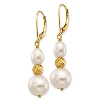 A pair of gold lever-back earrings with white pearl drops of varying sizes separated by textured gold beads.