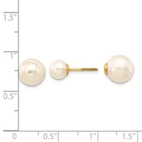 Two cream-colored pearl stud earrings on a gold post shown next to a ruler for scale, with the pearls measuring approximately one inch in diameter.