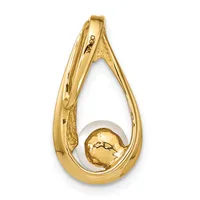 A polished gold teardrop-shaped pendant with a small gold sphere nestled inside the hollow opening.
