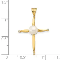 A gold cross pendant with a white pearl at the center and small diamonds at each arm, shown next to a ruler measuring approximately 1.25 inches in length.
