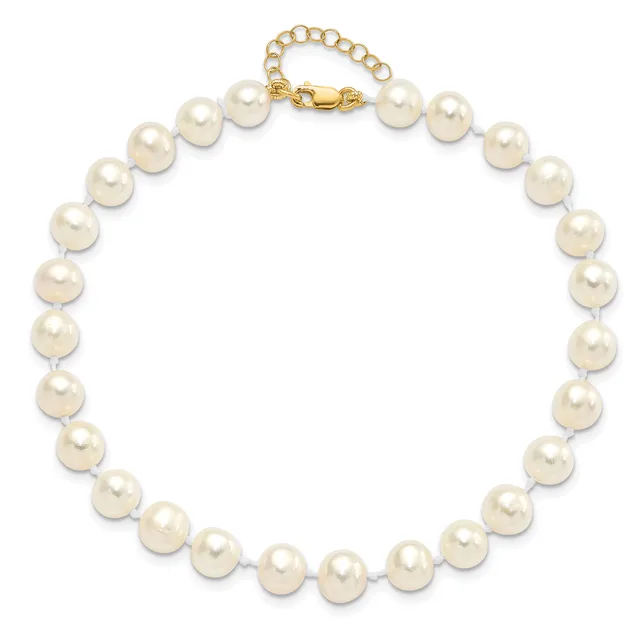 A cream-colored pearl necklace with a gold-toned clasp and extender chain displayed against a white background.