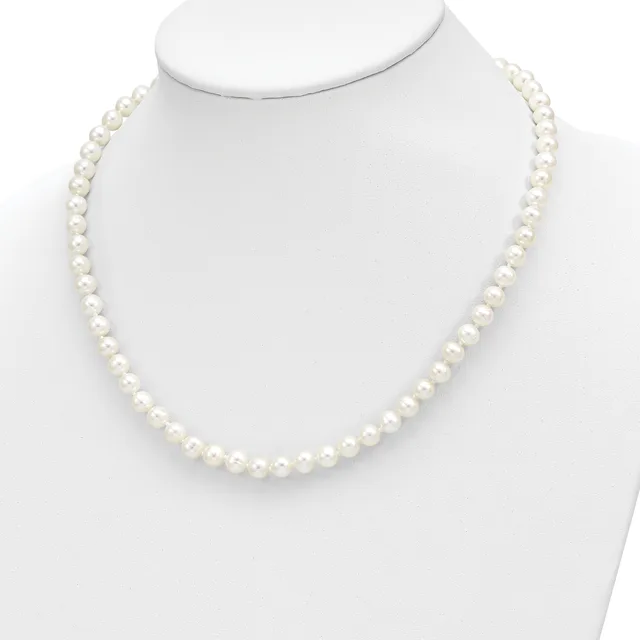 A strand of white pearls arranged in a continuous loop, displayed on a white mannequin bust against a white background.