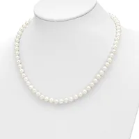 A strand of white pearls arranged in a continuous loop, displayed on a white mannequin bust against a white background.