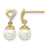 Pair of gold and diamond heart stud earrings with white pearl drops and small hallmarks on the posts.