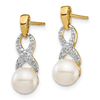 A pair of yellow and white gold dangle earrings with diamond-paved infinity symbols suspended above lustrous white pearl drops.