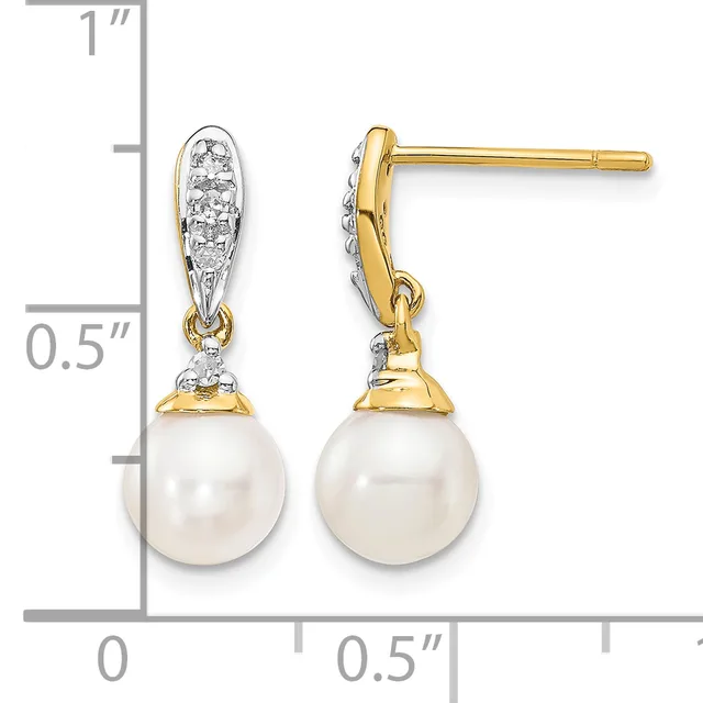 Pair of gold drop earrings with white pearl drops and diamond-set tops, shown next to a ruler measuring approximately one inch in length.