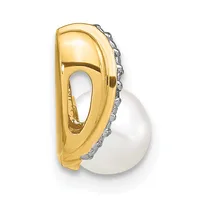 Gold pendant with a curved abstract design featuring a white pearl suspended below, accented with small diamonds along the edge.