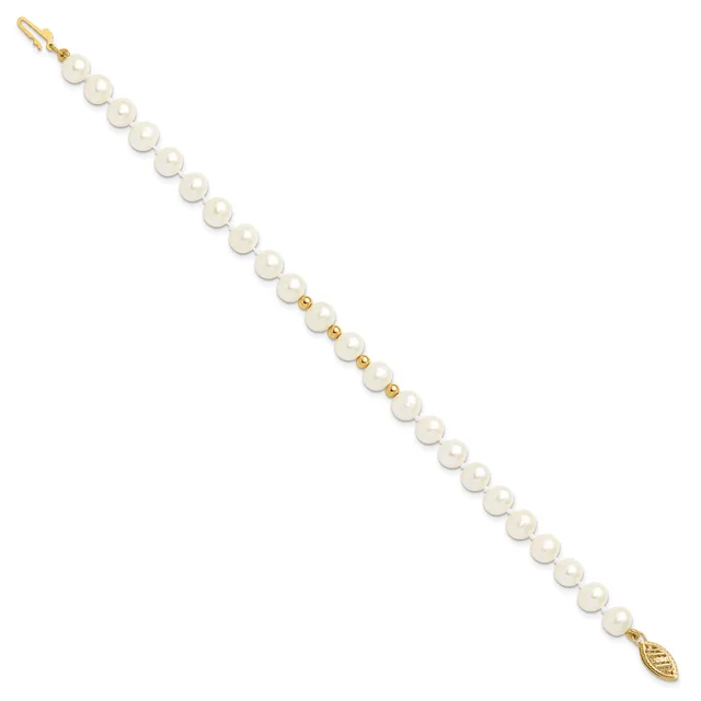 A gold-toned bracelet featuring white pearl beads separated by small gold spacer beads, with a lobster clasp and decorative leaf charm at the clasp end.