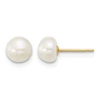 A pair of white pearl stud earrings with gold posts and backs, displayed against a white background.