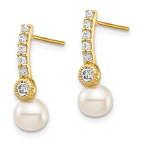 Pair of gold drop earrings with cubic zirconia studs along the post, decorative bezel settings, and cream-colored pearl drops, shown on a white background.