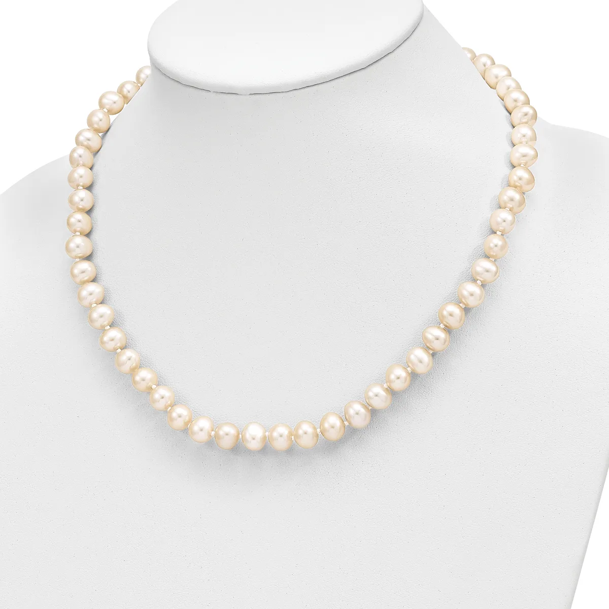 A single strand necklace of round cream-colored pearls displayed on a white mannequin bust.