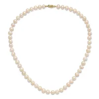 A string of round cream-colored pearls with a gold-toned clasp, displayed as a closed necklace against a white background.