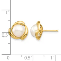 Pair of gold stud earrings with white pearl centers surrounded by curved gold loops, shown next to a ruler for scale.