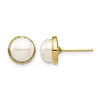 Pair of round white pearl stud earrings set in gold-tone metal, shown from front and side views.