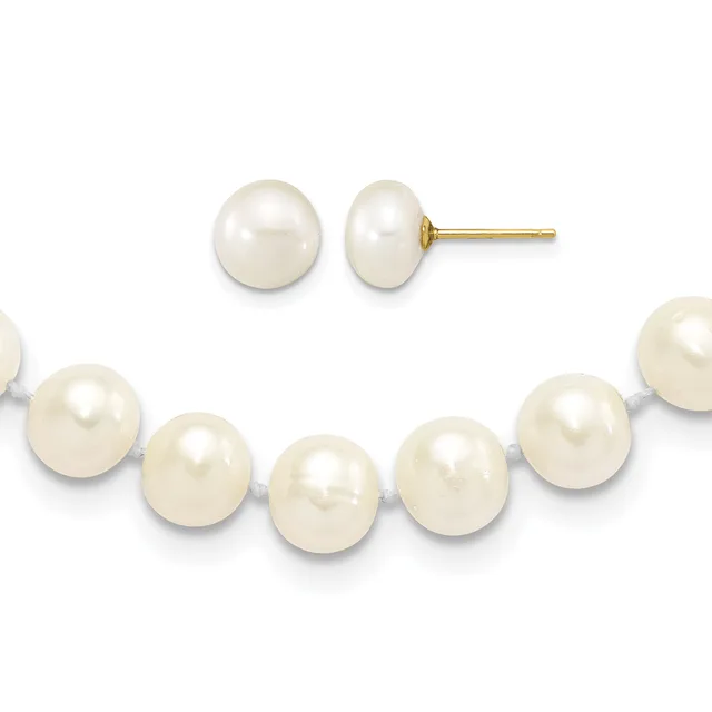 A pair of white pearl stud earrings with gold posts displayed above a white pearl bracelet with gray threading.