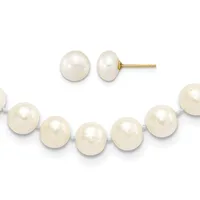 A pair of white pearl stud earrings with gold posts displayed above a white pearl bracelet with gray threading.