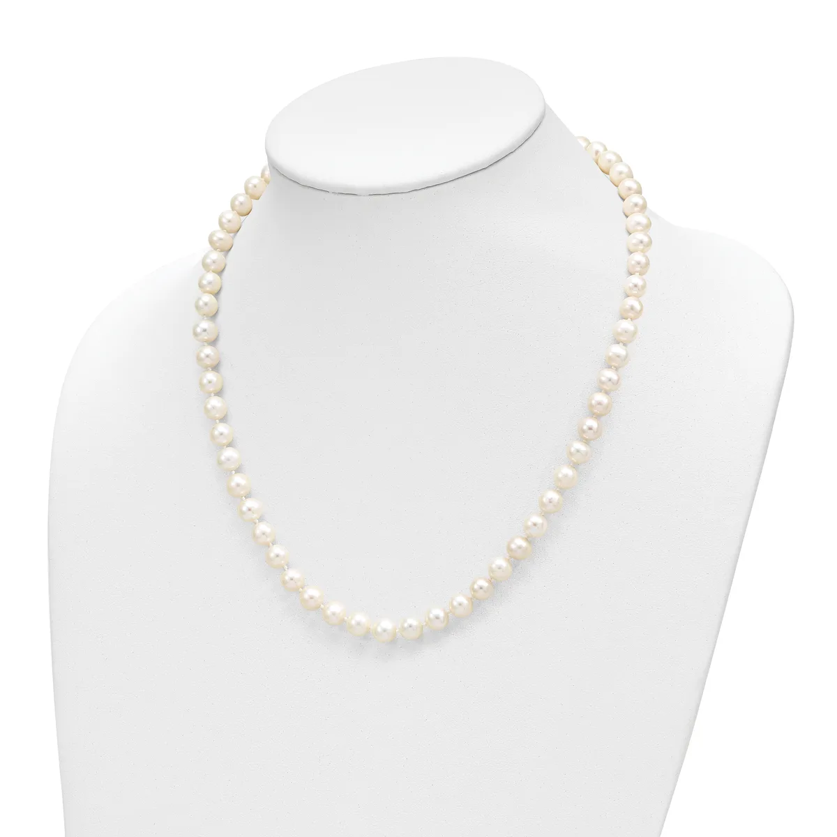 A single strand of cream-colored round pearls displayed on a white mannequin bust necklace form.
