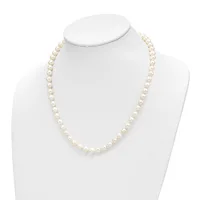 A single strand of cream-colored round pearls displayed on a white mannequin bust necklace form.