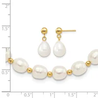 A gold-tone pearl jewelry set displayed against a measurement ruler, consisting of a bracelet with alternating white pearls and small gold spheres, and matching drop earrings with gold posts.