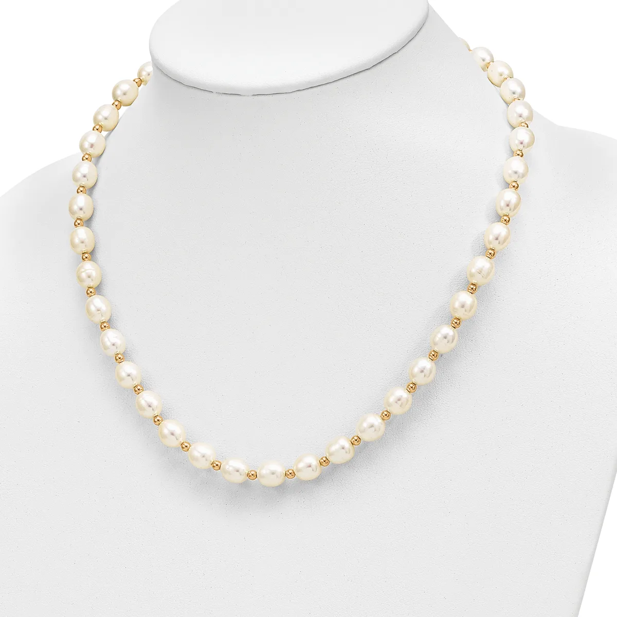 A necklace made of alternating cream-colored pearls and small gold-tone beads displayed on a white mannequin bust.