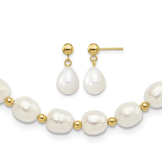 Gold-tone ball stud earrings with white pearl teardrop dangles paired with a bracelet of white pearls separated by small gold-tone beads.